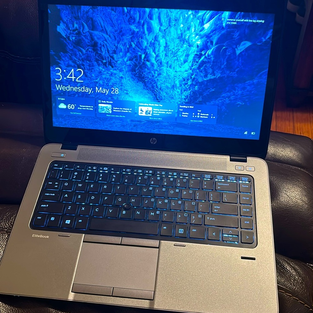 HP Silver and Black Laptop with Backlit Keyboard and Blue Display